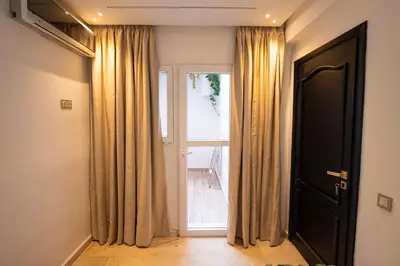an empty room with a large window and curtains at Marrakech Reverie Downtown in Marrakech