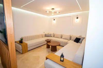a living room with a white couch and a table at Marrakech Reverie Downtown in Marrakech