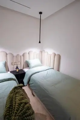 a bedroom with two beds and a headboard at Marrakech Reverie Downtown in Marrakech