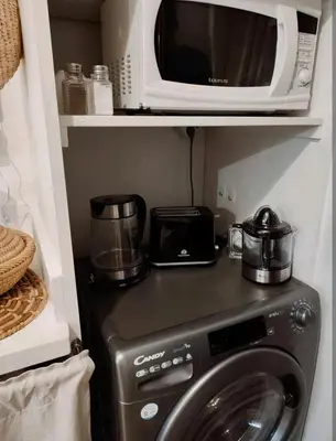 a microwave sitting on top of a washing machine at Studio au coeur de Guéliz in Marrakech