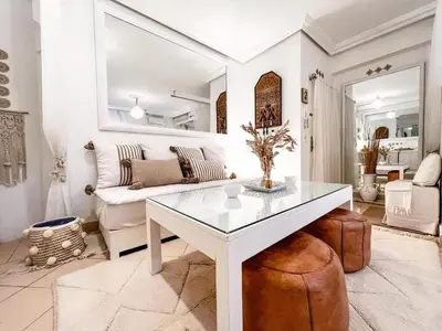 a living room with a white table and a couch at Studio au coeur de Guéliz in Marrakech
