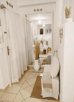 a living room with white curtains and a couch at Studio au coeur de Guéliz in Marrakech