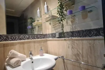 a bathroom with a sink and a mirror at appartement 2 chambres en plein centre ville gueliz marrakech in Marrakech