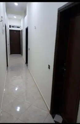 a hallway with two doors and a tile floor at Dar ALBIDAWI in Marrakech
