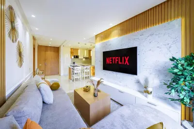 a living room with a television on a wall at Sérénité Tranquille Au Cœur du Centre Ville in Marrakech