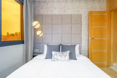 a bedroom with a white bed with a pillow on it at Sérénité Tranquille Au Cœur du Centre Ville in Marrakech