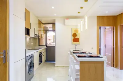 a kitchen with a counter and a dishwasher at Sérénité Tranquille Au Cœur du Centre Ville in Marrakech