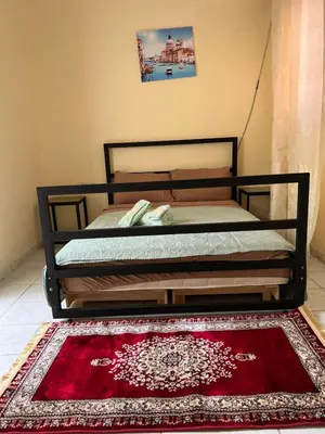 a bed in a room with a red rug at Amazing 3 Bedroom Riad Marrakech in Marrakech