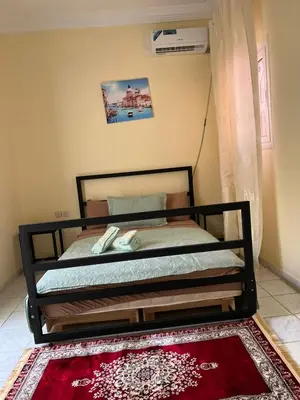 a bed in a room with a red rug at Amazing 3 Bedroom Riad Marrakech in Marrakech