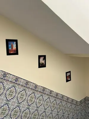 a wall with four pictures hanging on a wall at Amazing 3 Bedroom Riad Marrakech in Marrakech