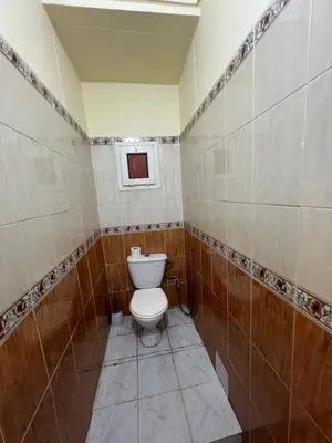 a bathroom with a toilet and a window in it at Amazing 3 Bedroom Riad Marrakech in Marrakech