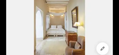 a bedroom with a bed and a couch and a chair at Riad Dar one in Marrakech