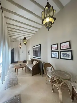 a living room with a couch and a table at Riad Dar one in Marrakech