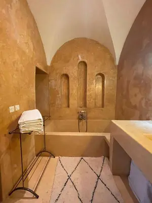 a bathroom with a bath tub and a sink at Riad Dar one in Marrakech