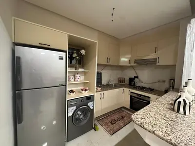 a kitchen with a refrigerator and a washer and dryer at Élégant Appartement Moderne familiale Marrakech in Marrakech