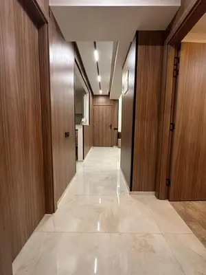 a hallway with wooden doors and a tile floor at Élégant Appartement Moderne familiale Marrakech in Marrakech