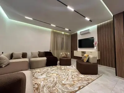 a living room with a couch and a flat screen tv at Élégant Appartement Moderne familiale Marrakech in Marrakech