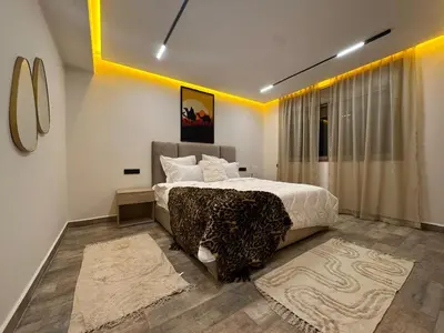 a bedroom with a large bed with a leopard blanket at Élégant Appartement Moderne familiale Marrakech in Marrakech