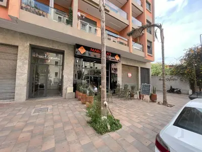 a building with a tree in front of it at Appartement neuf et cosy au coeur de Guéliz in Marrakech