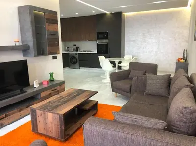 a living room with a couch and a tv at Appartement neuf et cosy au coeur de Guéliz in Marrakech