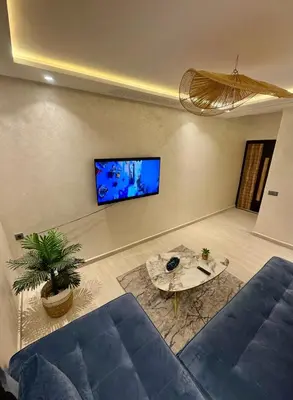 a living room with a blue couch and a table at The Blue Pearl - Fresh & Modern in Marrakech