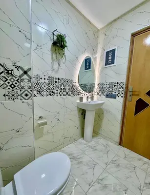 a white bathroom with a sink and a toilet at The Blue Pearl - Fresh & Modern in Marrakech