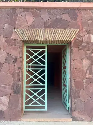 an opening in a stone building with a door at Somptueux appartement jardin & piscine - Hivernage in Marrakech