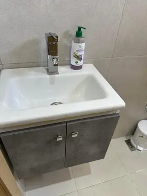 a bathroom sink with a bottle of soap on it at Gorgeous newly renovated apt- Near Restaurant and Shopping Center in Marrakech