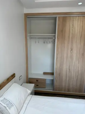 a bedroom with a bed and a sliding glass door at Gorgeous newly renovated apt- Near Restaurant and Shopping Center in Marrakech