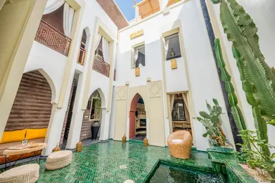 a courtyard in a house with a pool in the middle at Riad EYNA Marrakech Medina in Marrakech