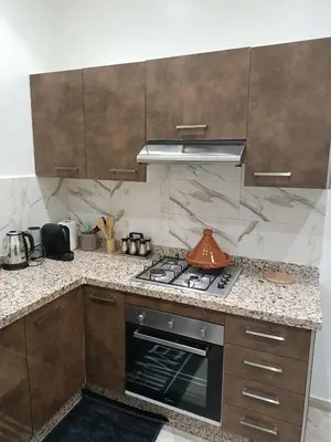 a kitchen with a stove and a tea kettle on it at Oasis Appart in Marrakech