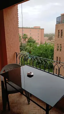 a bench sitting on a balcony with a view at Marrakech appartement babylon2 in Marrakech