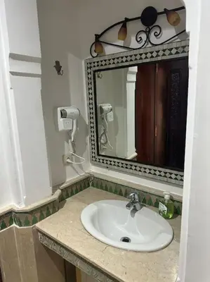 a bathroom with a sink and a mirror at Marrakech appartement babylon2 in Marrakech