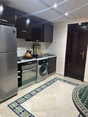 a kitchen with a stove and a washer and dryer at Marrakech appartement babylon2 in Marrakech