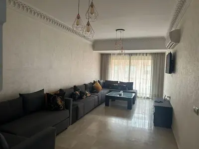 a living room with a couch and a coffee table at Marrakech appartement babylon2 in Marrakech