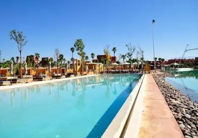 a large pool with blue water in a resort at Appart 2ch Marrakech in Sraghna