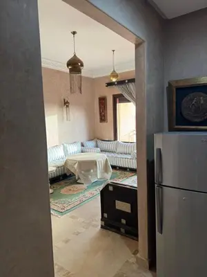 a kitchen with a living room with a refrigerator at Appart 2ch Marrakech in Sraghna