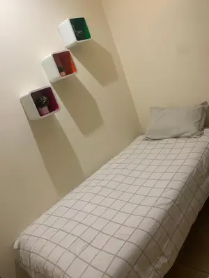 a bedroom with a bed with three shelves on the wall at The Red Flat in Marrakech