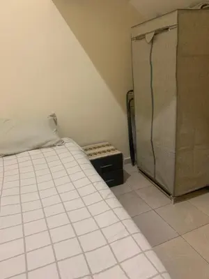 a small bedroom with a bed and a dresser at The Red Flat in Marrakech