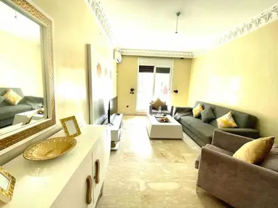 a living room with a couch and a mirror at Guéliz appartemment Piscine à la résidence in Marrakech