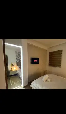a bedroom with a bed and a clock on the wall at Stylish Appartement in Marrakech in Marrakech