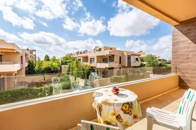 a balcony with a table and chairs and a large window at Villa Gina, chic et Moderne avec piscine&terrasse in Marrakech