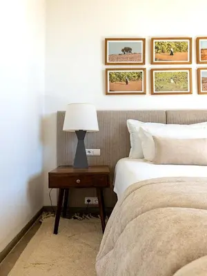 a bedroom with two beds and a table with a lamp at Palais Noor in Douar Caïd Layadi