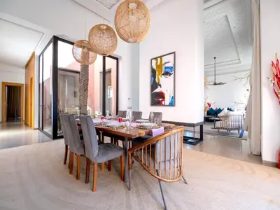 a dining room with a table and chairs at Palais Noor in Douar Caïd Layadi