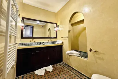 a bathroom with a sink and a mirror at Riad Sarasvati & SPA in Marrakech