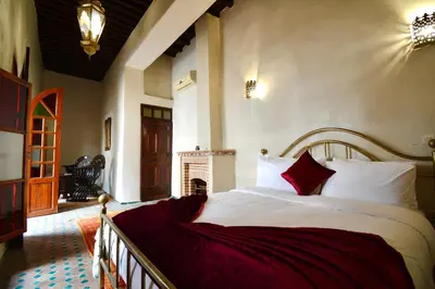 a bedroom with a bed and a fireplace at Riad Sarasvati & SPA in Marrakech