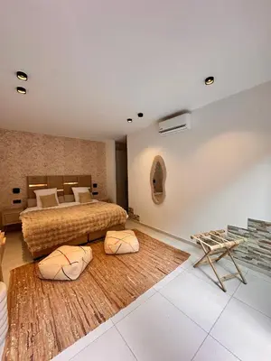 a bedroom with a bed and two pillows at Villa Jassmir 5 chambres 10 min du centre piscine chauffée in Marrakech