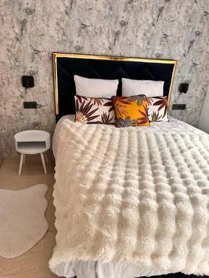 a bedroom with a large white bed with pillows at Villa Jassmir 5 chambres 10 min du centre piscine chauffée in Marrakech