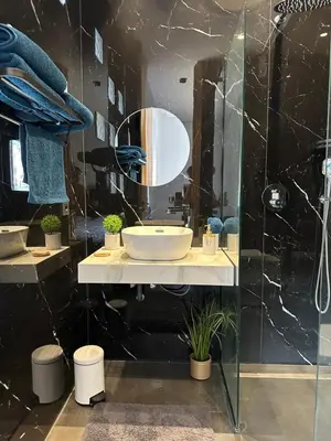a bathroom with a sink and a mirror at Villa Jassmir 5 chambres 10 min du centre piscine chauffée in Marrakech