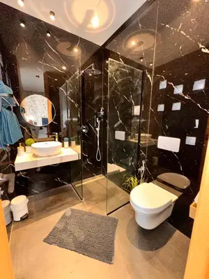 a bathroom with a shower and a toilet and a sink at Villa Jassmir 5 chambres 10 min du centre piscine chauffée in Marrakech